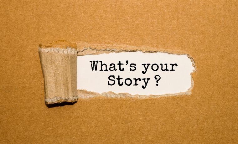 The text What's your story? appearing behind torn brown paper The text What's your story? appearing behind torn brown paper